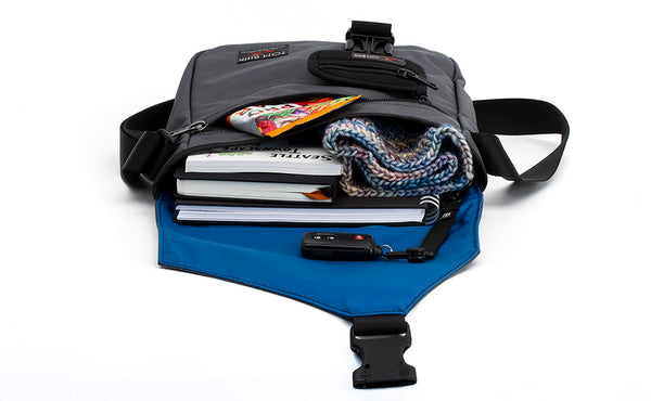 A shot of the main compartment of the Medium Cafe Bag with books, a scarf, and a key fob.